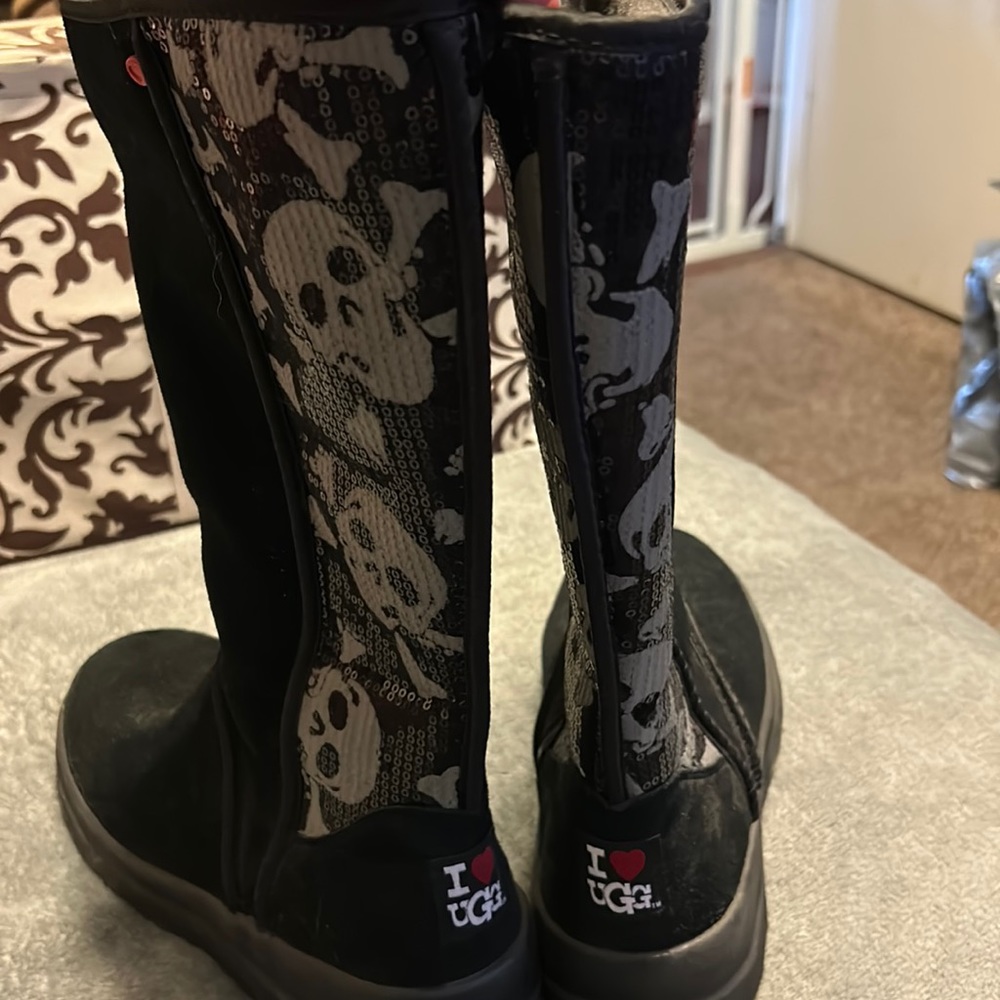 UGGs. Black and gray skeletons on the back of the boot. Size US8